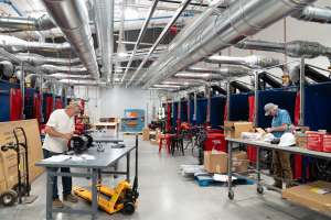 Two men working inside AMTC.